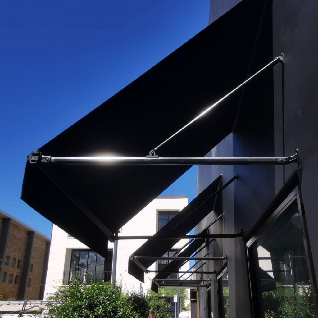 Fixed Pivot Arm Awning by Outdoor Blinds and Awnings (OBA)